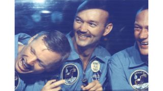 The Apollo 11 crew smiles in quarantine after the 1969 mission. From left to right: astronauts Neil Armstrong, Michael Collins and Buzz Aldrin.