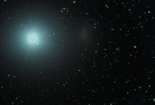 pale blue bright light against starry background