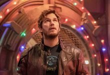 Chris Pratt as Peter Quill/Star-Lord in front of holiday lights adorning a metal entrance in The Guardians of the Galaxy Holiday Special